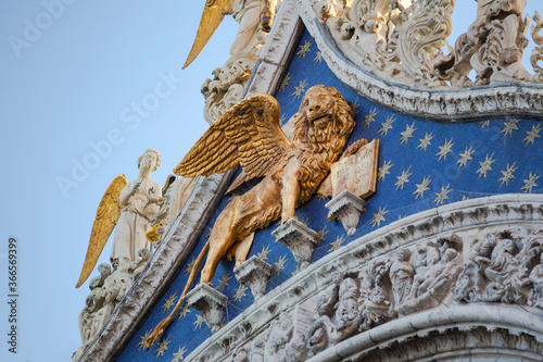 Close up detail of the golden Lion of Venice statue on the outside of St Mark's Basilica 