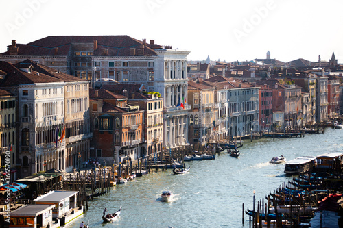Old Colorful Buildings line the Grand Canal in Venice Italy with Gondola boats and docks in summer part 2