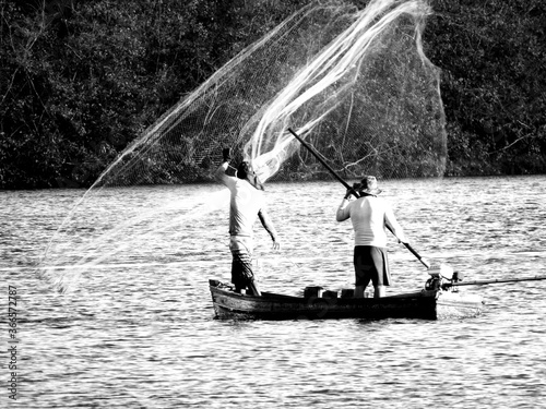 Rio João de Tiba, river fishing, fisherman, fisherman in canoe, pole photo