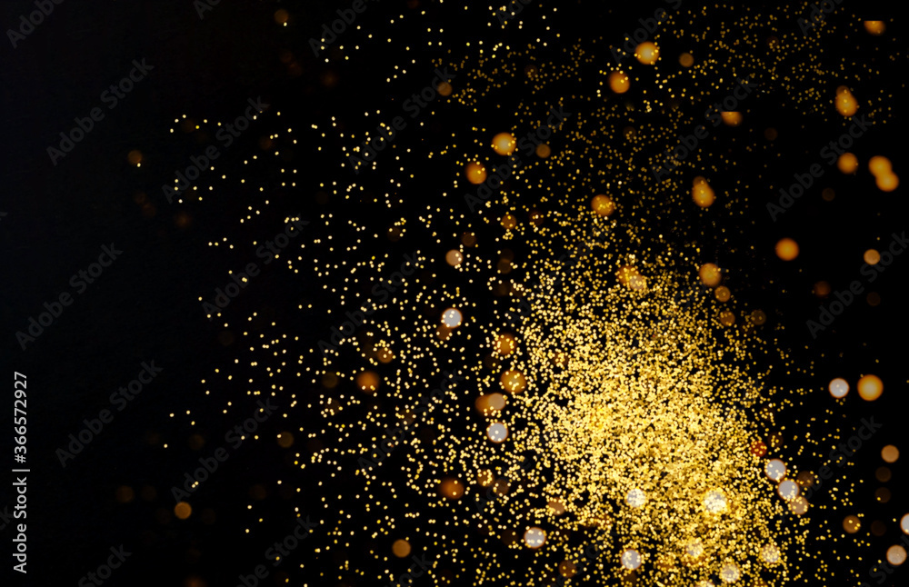 Abstract dark background with golden sparkles. Blurred effect. Concept for festive background or for project.