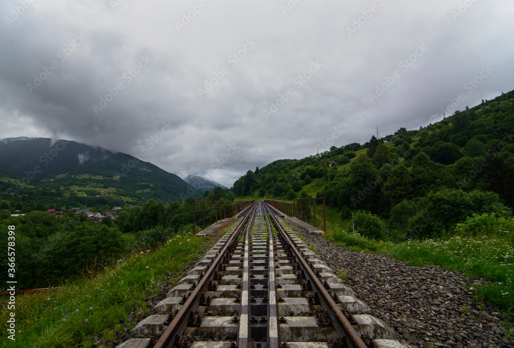 railway in the mountains. Mountains in clouds. Journey begins