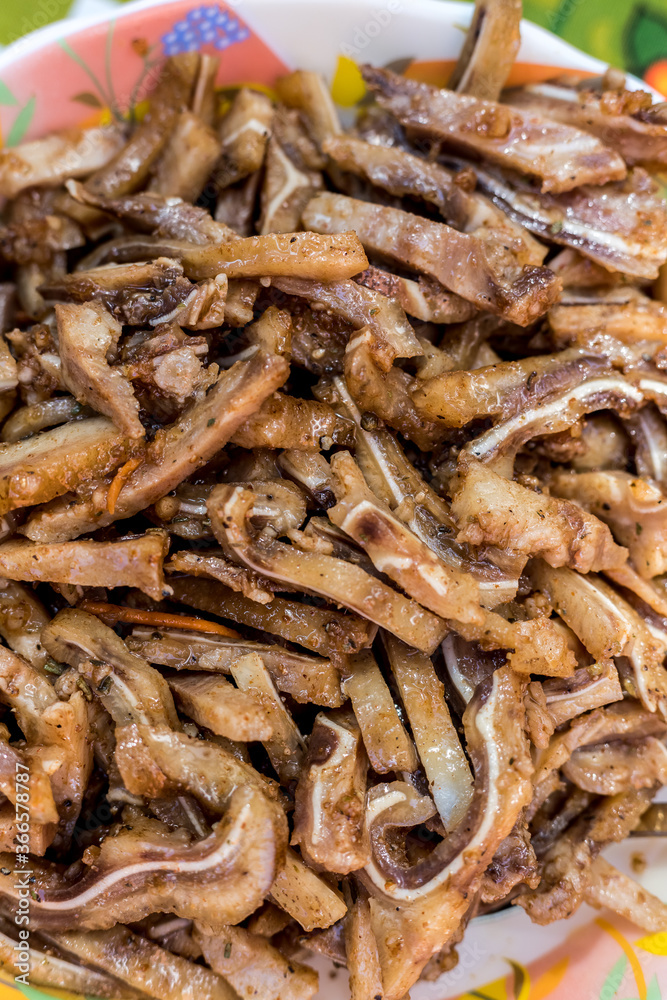 A cooked dish made from pork ears. Delicacy. The dish is on our table.