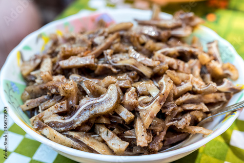 A cooked dish made from pork ears. Delicacy. The dish is on our table. © Viktoriia Varvashche