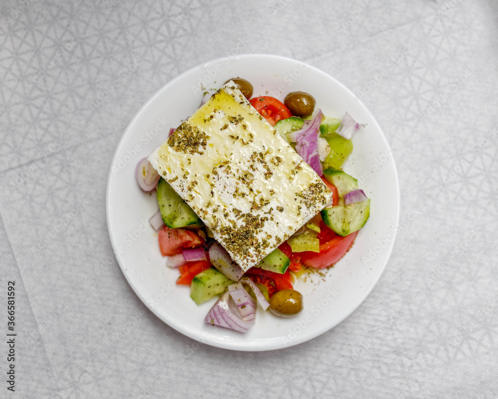 fresh Greek salad plate top view on pale white surface background