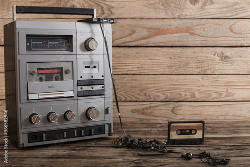 old tape recorder and cassette on  wooden background