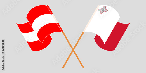 Crossed and waving flags of Malta and Austria