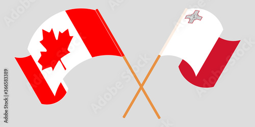 Crossed and waving flags of Malta and Canada