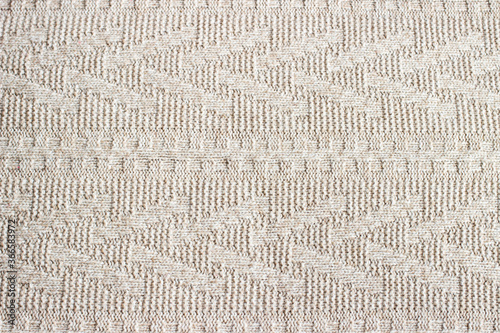 Fabric background. Texture of knitted wool pattern. Beige color.