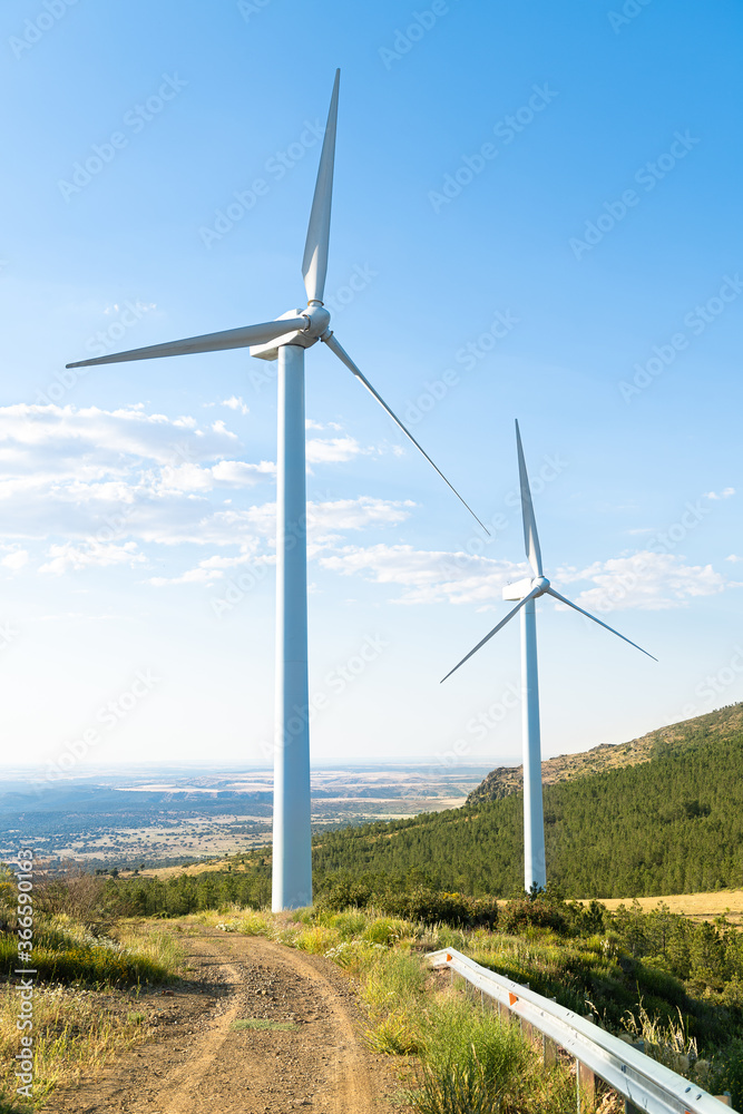 turnina wind in the foreground with green countryside and bluish sky.. turnina wind in the foreground with green countryside and bluish sky..
