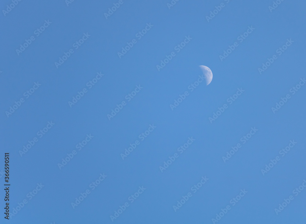 The moon in the blue sky during the day The moon in the blue sky during the day