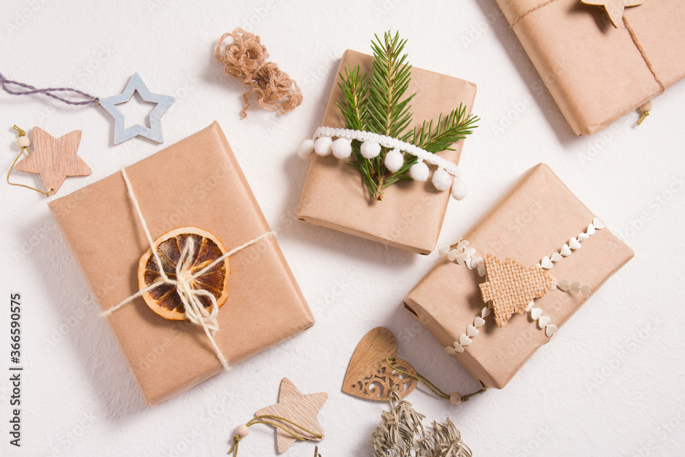 several gift boxes decorated in eco style on a white background, gifts for new year or christmas, zero waste lifestyle, packaging of gifts from natural materials concept several gift boxes decorated in eco style on a white background, gifts for new year or christmas, zero waste lifestyle, packaging of gifts from natural materials concept