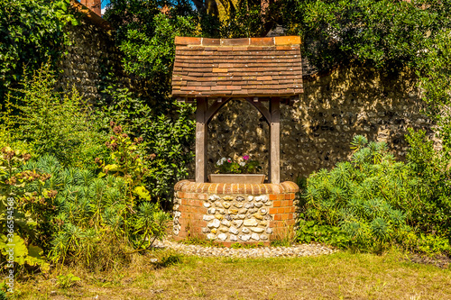 A wishing well in the town of Rottingdean, Sussex, UK in summer photo