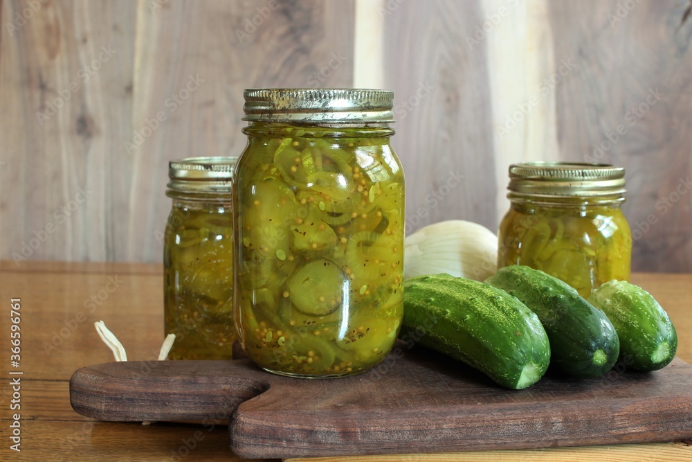 home canned pickles in glass jars made with fresh cucumbers from a family vegetable garden home canned pickles in glass jars made with fresh cucumbers from a family vegetable garden