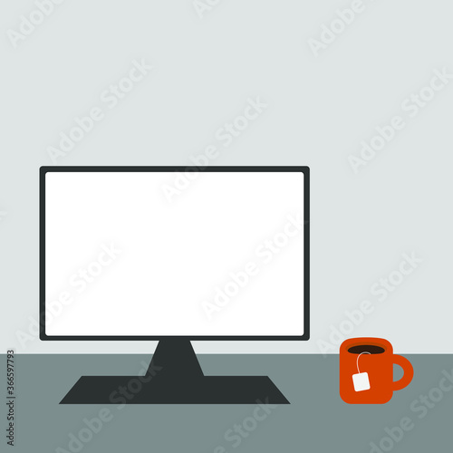Computer monitor and a cup on the table