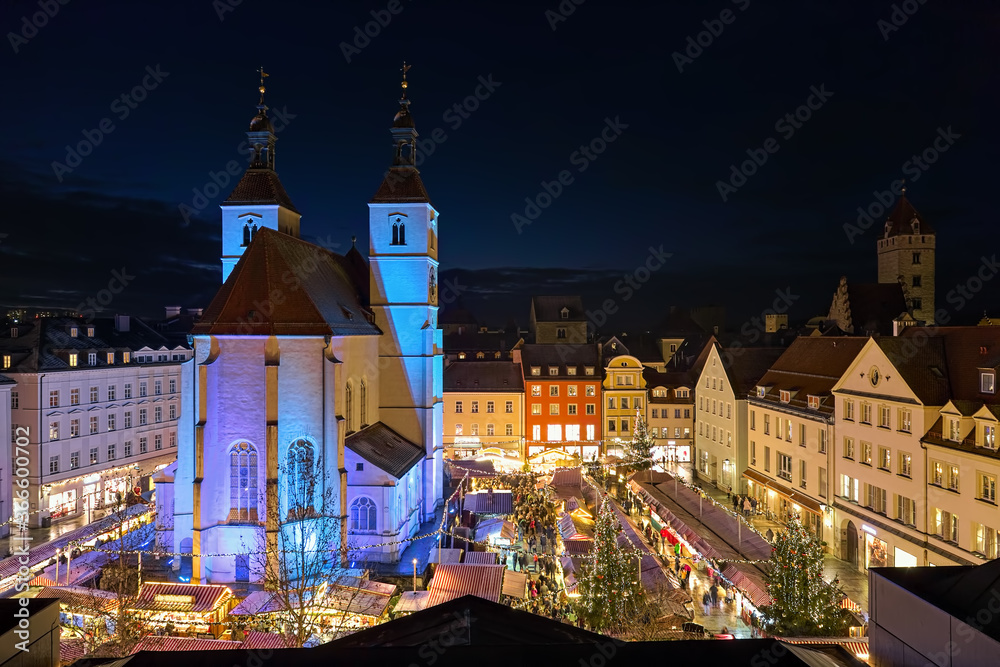 Regensburg, Germany. High angle view of the city's main Christmas market on the Neupfarrplatz (New Parish Square) around the Neupfarrkirche (New Parish Church) in dusk.