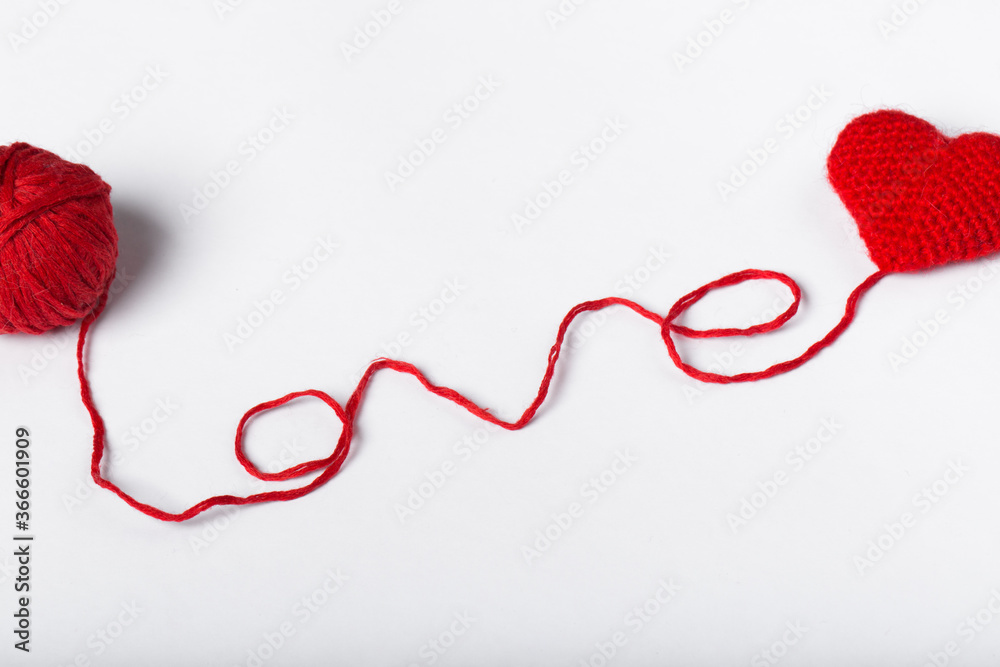 Close up of a wool ball and heart shape on white background. Heart shaped woolen yarn. Love Crochet. Close up of a wool ball and heart shape on white background. Heart shaped woolen yarn. Love Crochet.