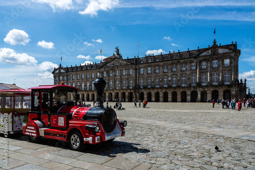 Tren turístico en la Plaza del Obradoiro junto a la Catedral de Santiago de Compostela frente al ayuntamiento de Raxoi. photo