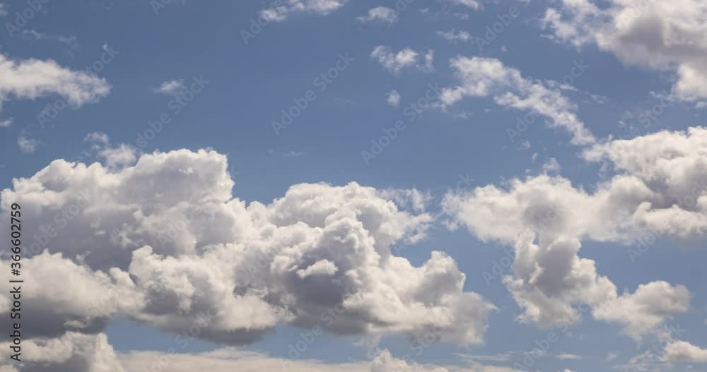 Time lapse clip of several fluffy curly rolling cloud layers in windy weather at blue sky Time lapse clip of several fluffy curly rolling cloud layers in windy weather at blue sky