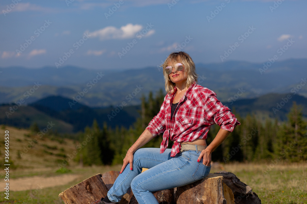 Naklejka premium cute girl in denim clothes in the carpathian mountains