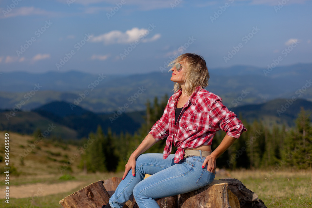 Naklejka premium cute girl in denim clothes in the carpathian mountains