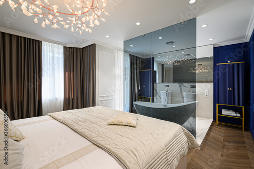 Billede på lærred Big comfortable double bed in elegant classic bedroom