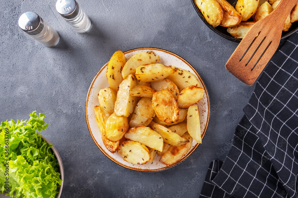Baked potato with thyme on a plate. Top view Baked potato with thyme on a plate. Top view