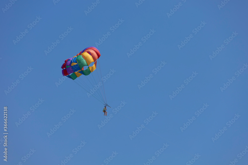 Parasailing, also known as parascending or parakiting, is a recreational kiting activity where a person is towed behind a vehicle (usually a boat) while attached to a specially designed canopy wing Parasailing, also known as parascending or parakiting, is a recreational kiting activity where a person is towed behind a vehicle (usually a boat) while attached to a specially designed canopy wing