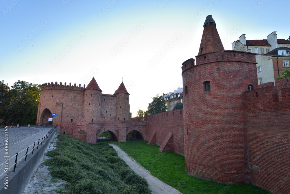 The Barbican Tower in the Warsaw Old Town in the light of the rising sun.