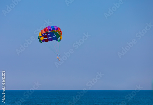 Parasailing, also known as parascending or parakiting, is a recreational kiting activity where a person is towed behind a vehicle (usually a boat) while attached to a specially designed canopy wing
