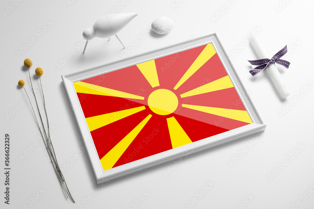 Macedonia flag in wooden frame on table. White natural soft concept, national celebration theme. Macedonia flag in wooden frame on table. White natural soft concept, national celebration theme.