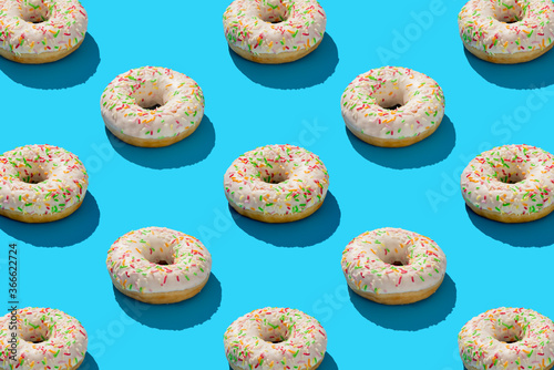 white donuts with sprinkles on blue background