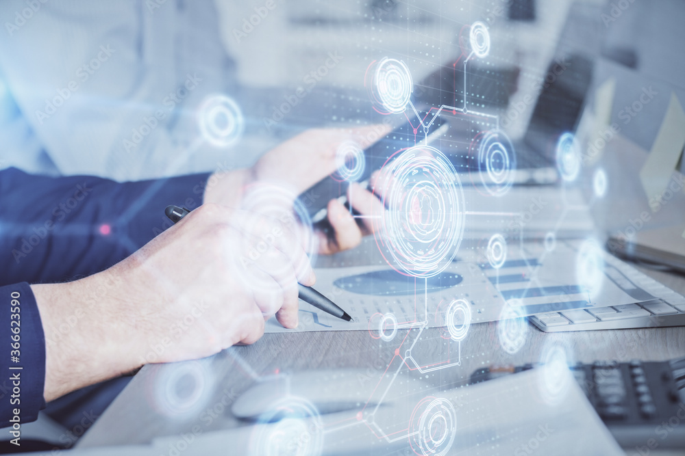 Double exposure of man's hand holding and using a digital device and data theme hologram drawing. Technology concept. Double exposure of man's hand holding and using a digital device and data theme hologram drawing. Technology concept.