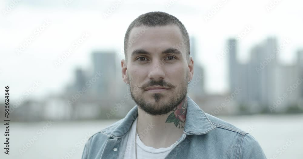 Portrait of young adult male with beard and moustache looking at camera confident Portrait of young adult male with beard and moustache looking at camera confident