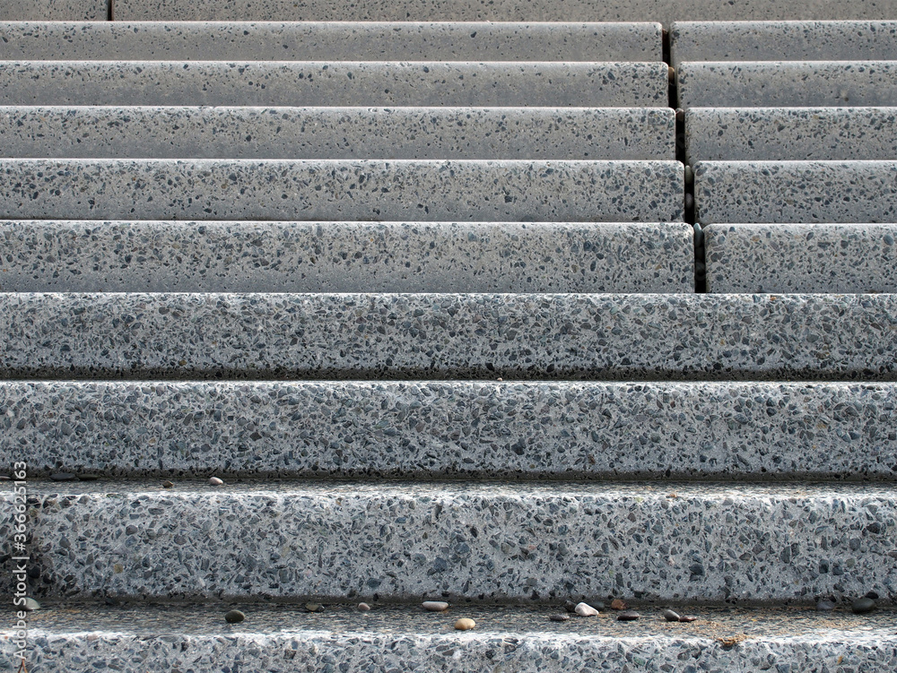 grey textures outdoor concrete stairs with small pebbles on the bottom step