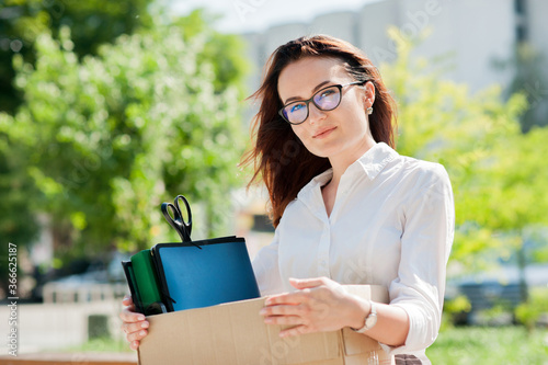young woman holding a box of documents
