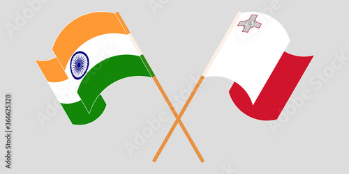 Crossed and waving flags of Malta and India