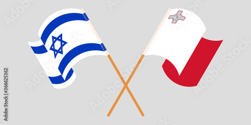 Crossed and waving flags of Malta and Israel