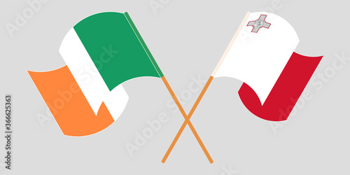 Crossed and waving flags of Malta and Ireland