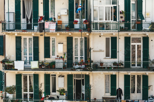 Rows of windows and balconies of an apartment  building in Savona, Italy
