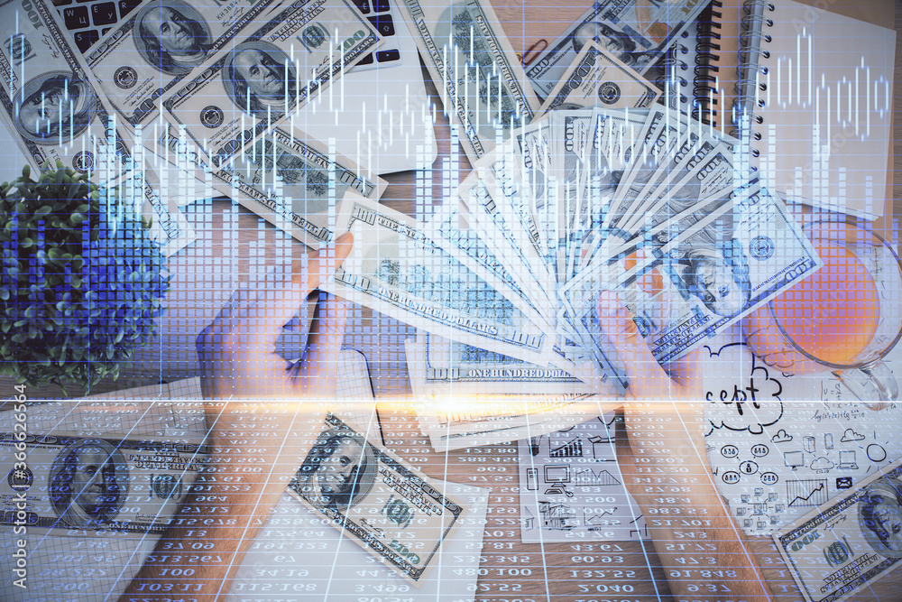 Multi exposure of financial graph drawing hologram and USA dollars bills and man hands. Analysis concept. Multi exposure of financial graph drawing hologram and USA dollars bills and man hands. Analysis concept.