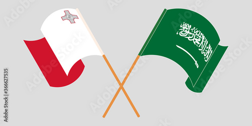 Crossed and waving flags of Malta and the Kingdom of Saudi Arabia