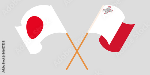 Crossed and waving flags of Malta and Japan