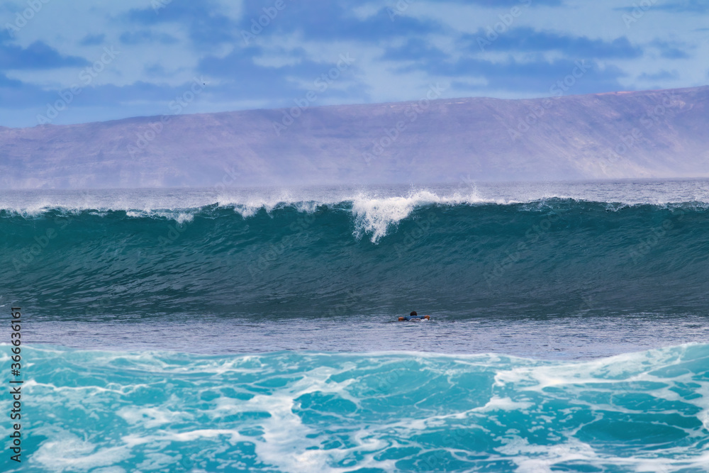 Big cresting wave rolling in to shore on Maui.