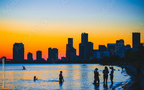 city skyline at sunset miami florida beach buildings people downtown colors orange blue summer 