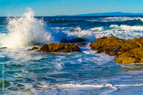 Waves crashing in to rocks on the shores of Pacific Ocean in California