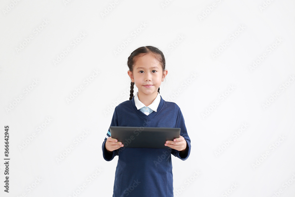 Portrait of asian little child girl in school uniform using tablet isolated on white background with looking at camera Portrait of asian little child girl in school uniform using tablet isolated on white background with looking at camera