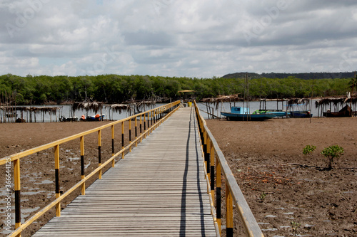 conde, bahia / brazil - march 28, 2013: wooden point of access to the Itapicuru River margin in Siribinha district, Conde municipality, north coast of Bahia.

 photo