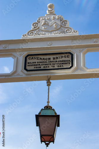 Singapore Jun 30th 2020： The closeup image of name plate and lantern of Cavenagh Bridge. It is the only suspension bridge and one of the oldest bridges in Singapore. photo