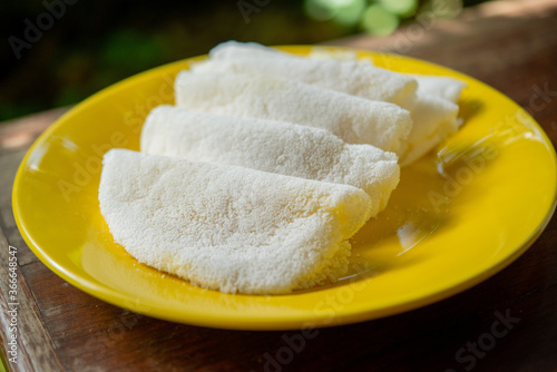 Butter and cheese tapioca served on a yellow plate. photo
