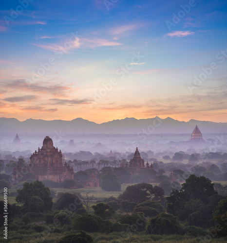 Pagoda landscape of Bagan in misty morning,under a warm sunrise in the plain of Bagan